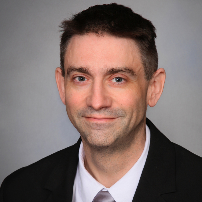 photo of white man with short dark hair smiling