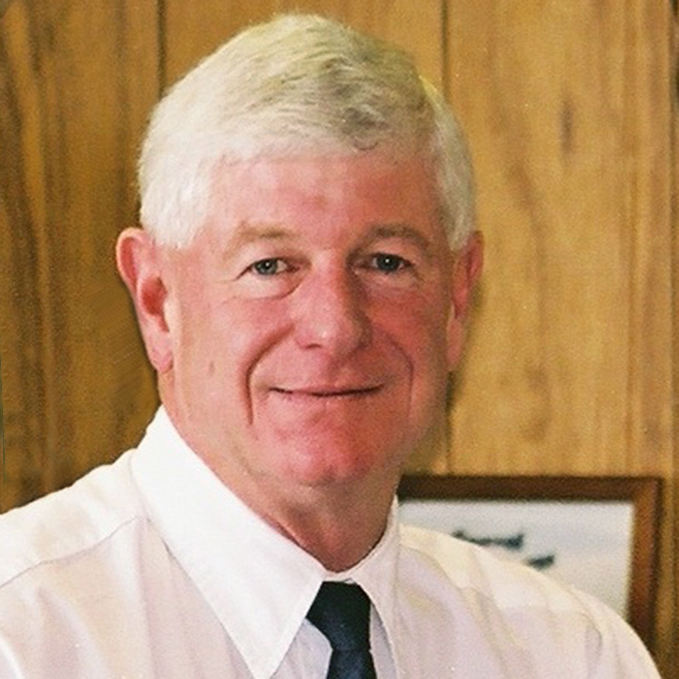 photo of a white-haired man in a white shirt