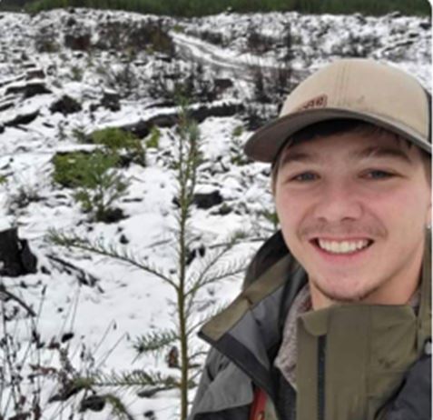 Profile photo of Cole (Forestry graduate) smiling in front of snowy wooded area outside